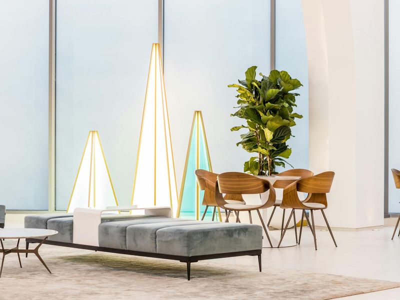 A calm and spacious room with yoga mats and soft lighting.